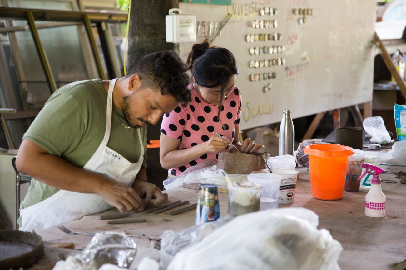 Two artists working with clay in the ceramics studio