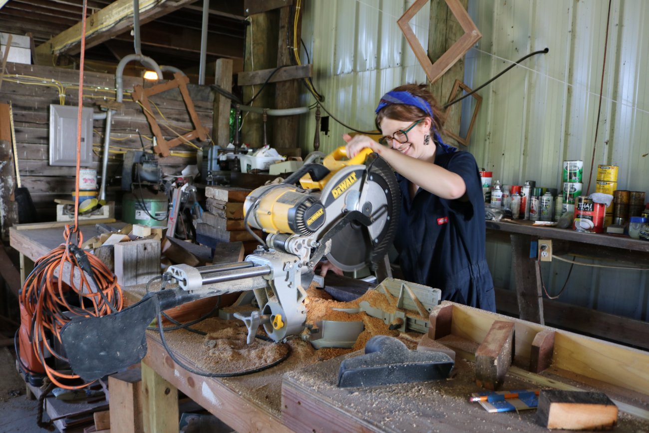 Woodshop tech using saw 