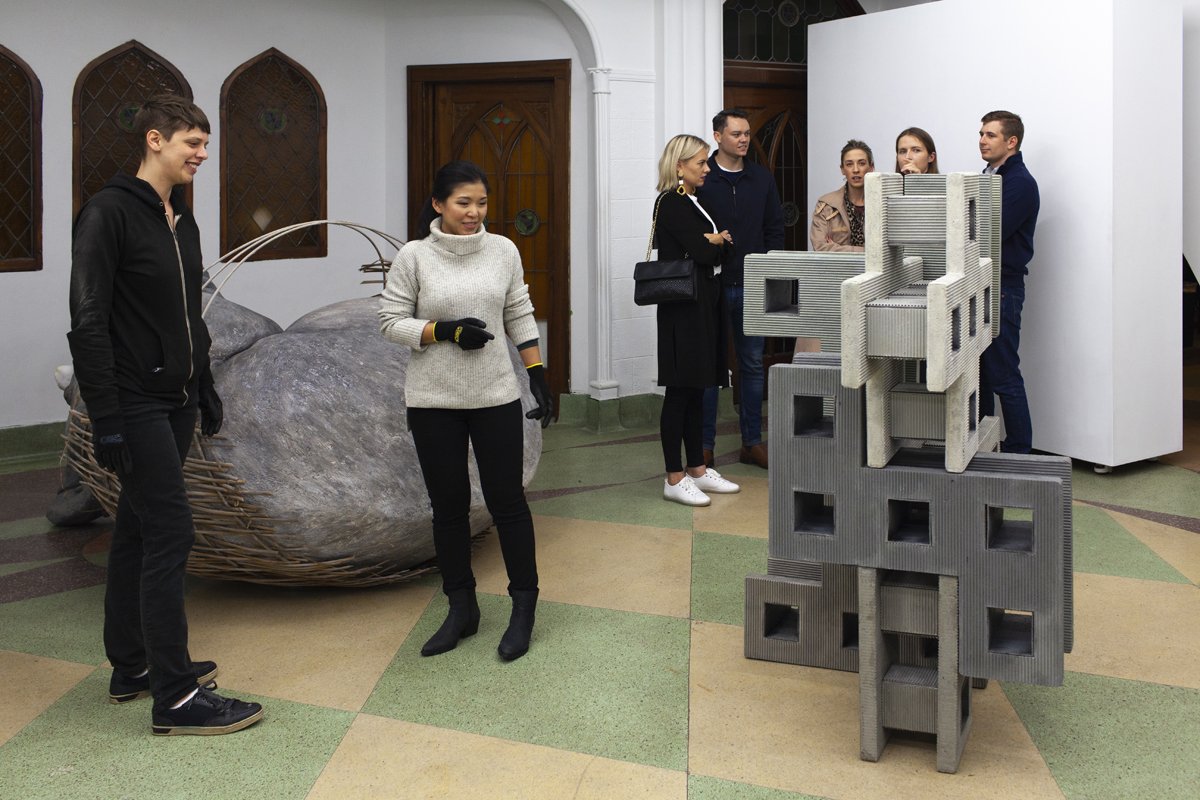 Exhibition visitors playing with cement blocks