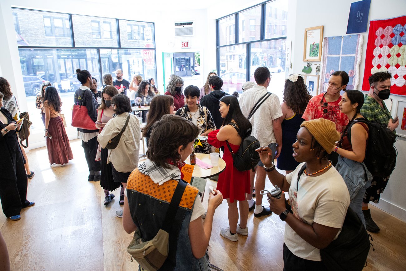 Group of people interacting in sunlit gallery space